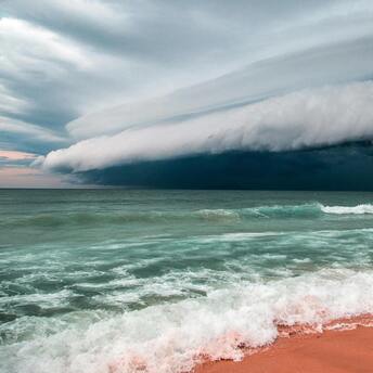 Stormy clouds approaching over the ocean waves