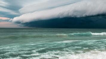 Stormy clouds approaching over the ocean waves