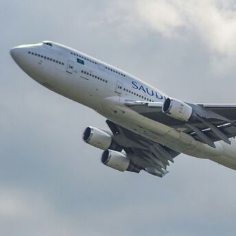 Saudia Airlines Boeing 747-400 aircraft taking off against a cloudy sky