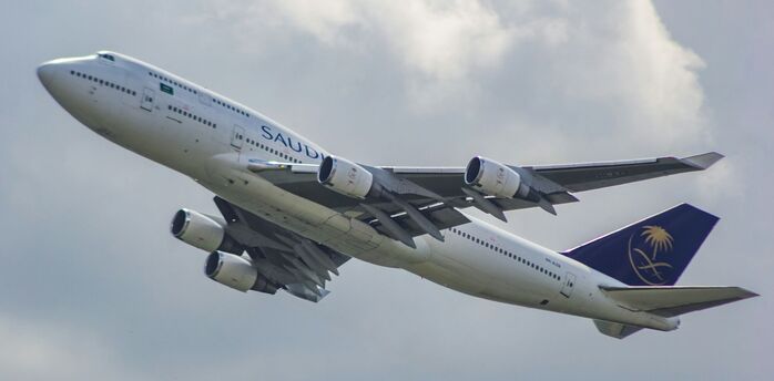 Saudia Airlines Boeing 747-400 aircraft taking off against a cloudy sky