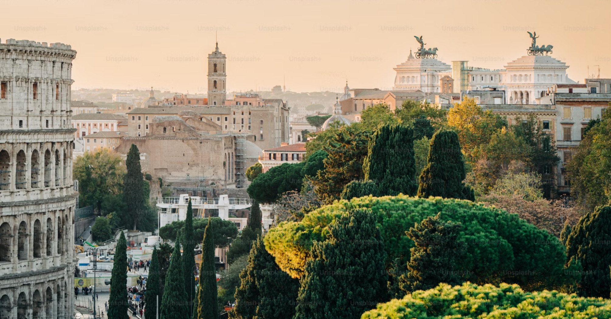 Panoramic view of Rome with the Colosseum and historic landmarks surrounded by lush greenery