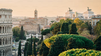 Panoramic view of Rome with the Colosseum and historic landmarks surrounded by lush greenery
