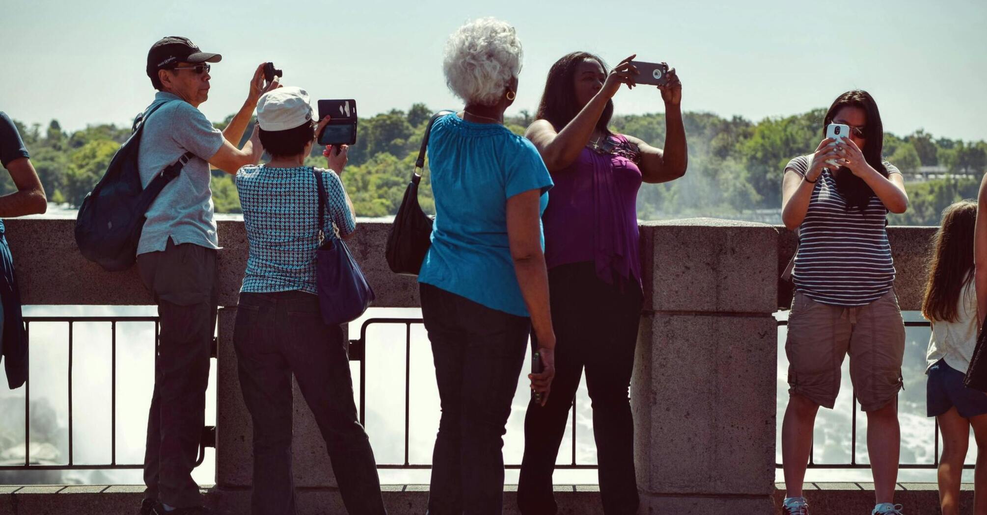 Tourists taking photos at a scenic viewpoint