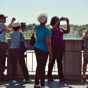 Tourists taking photos at a scenic viewpoint