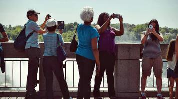Tourists taking photos at a scenic viewpoint