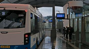 Modern bus GVB at a sheltered station with kids in Amsterdam
