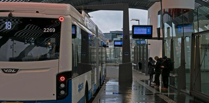 Modern bus GVB at a sheltered station with kids in Amsterdam