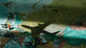 Shadow of an airplane over a map of Europe