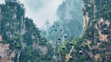 Cable cars amidst towering cliffs in Zhangjiajie
