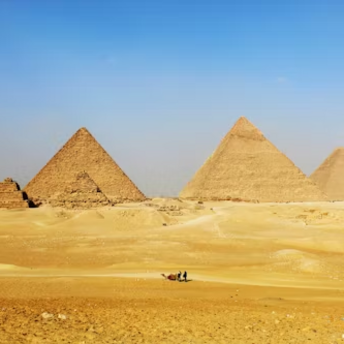 Pyramids of Giza standing tall in the desert under a clear blue sky