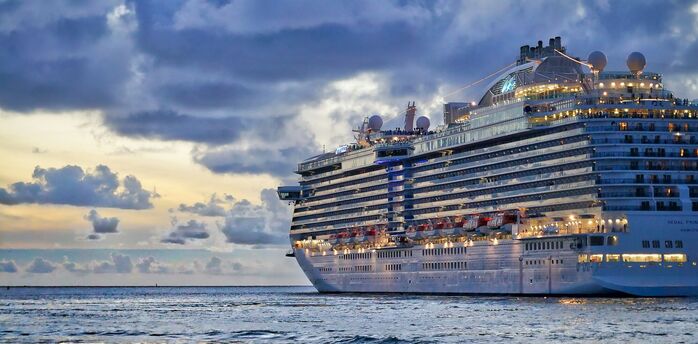 A luxury cruise ship at sea under cloudy skies