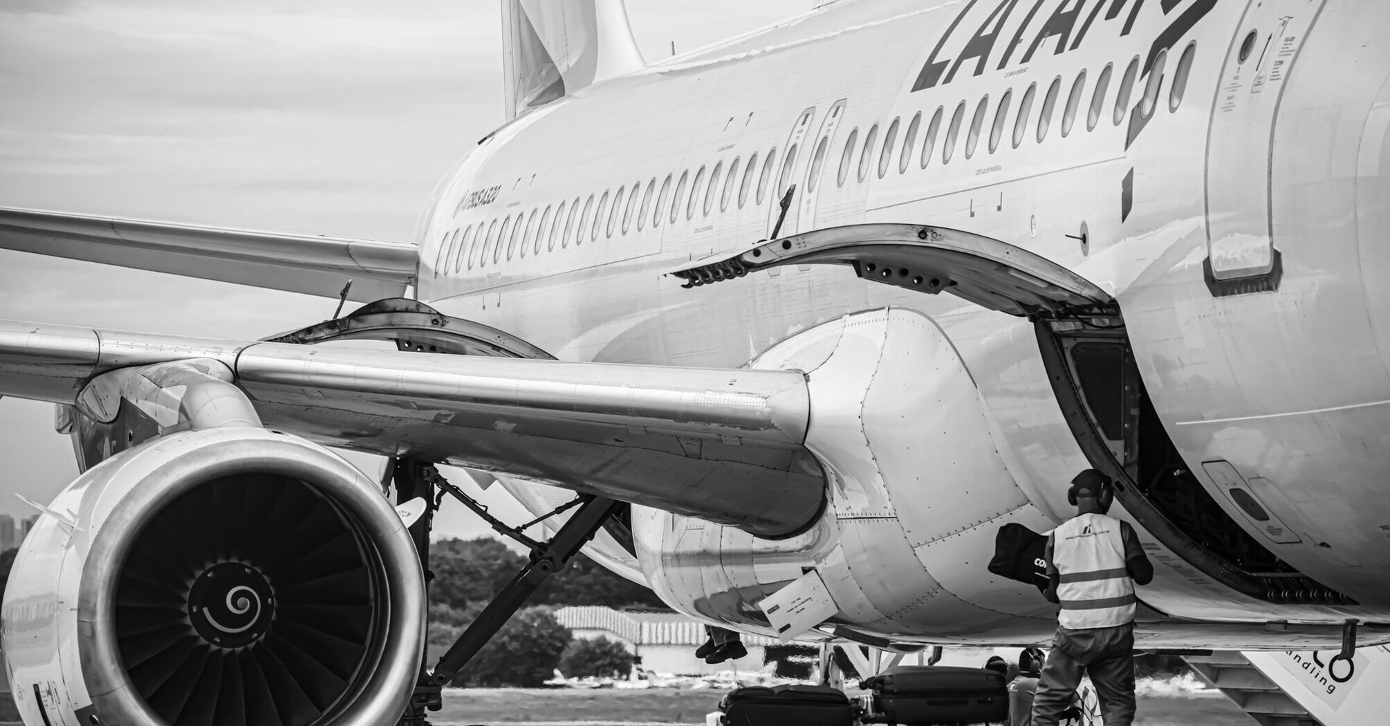 A LATAM Airlines airplane being loaded with luggage at an airport