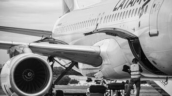 A LATAM Airlines airplane being loaded with luggage at an airport
