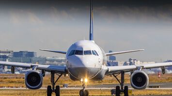 A passenger airplane on a runway at an airport