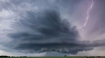 A dramatic thunderstorm with dark clouds and lightning striking over a field, showcasing severe weather conditions