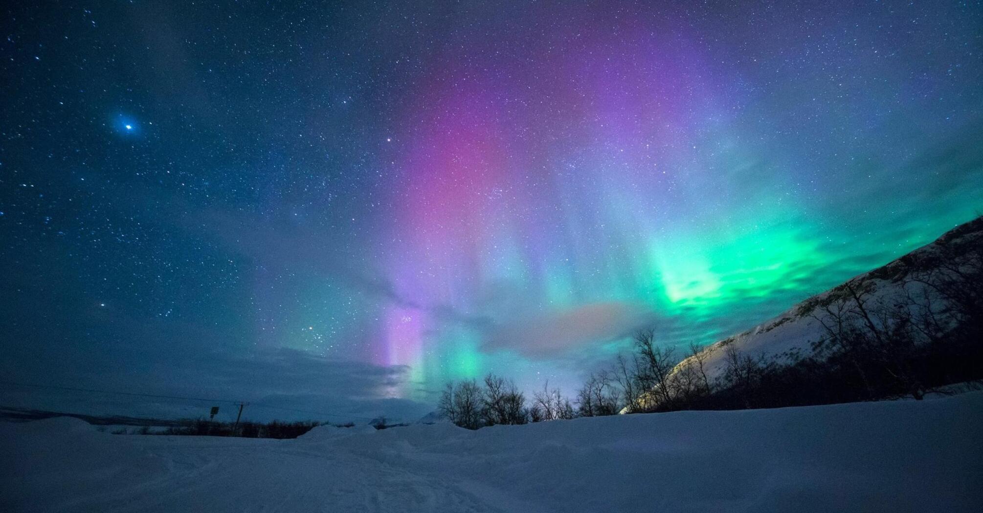 Northern Lights with vibrant colors over snowy landscape