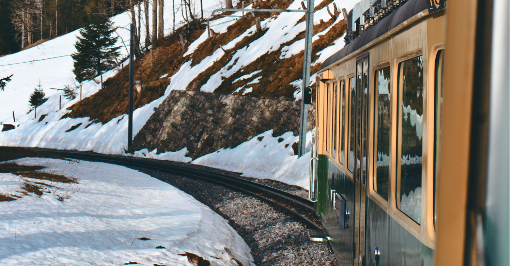 Panoramic view from a train in snowy Swiss Alps