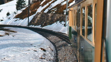 Panoramic view from a train in snowy Swiss Alps