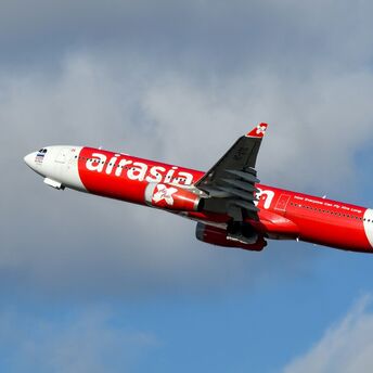 AirAsia X aircraft in flight against a clear sky