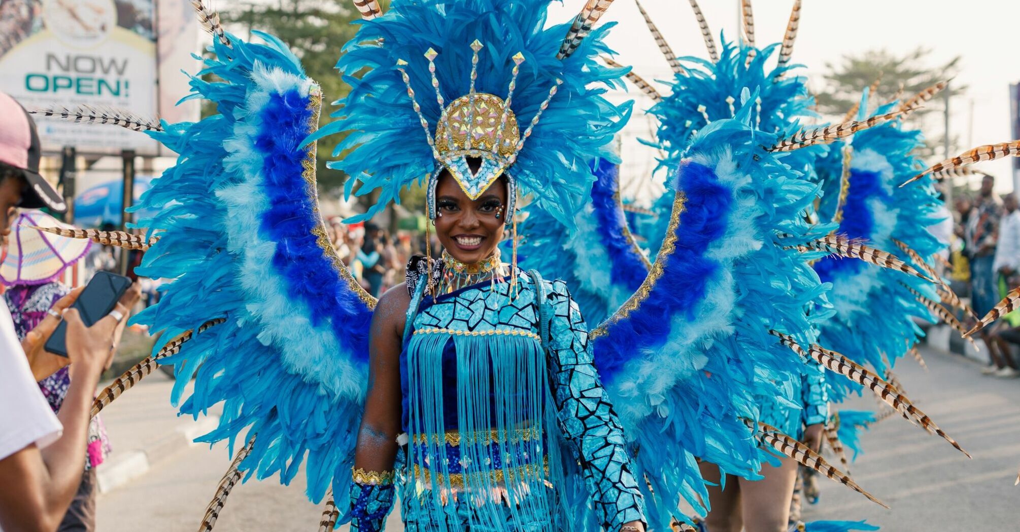 Performer in vibrant blue costume at Calabar Carnival