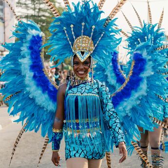 Performer in vibrant blue costume at Calabar Carnival