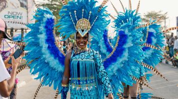Performer in vibrant blue costume at Calabar Carnival