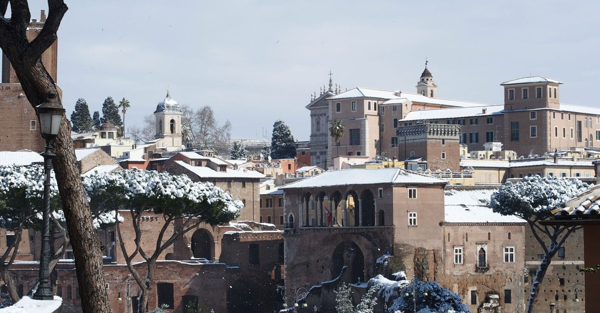 Snow-covered rooftops and landmarks in Rome during winter