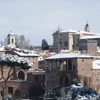 Snow-covered rooftops and landmarks in Rome during winter