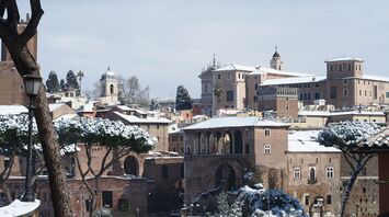 Snow-covered rooftops and landmarks in Rome during winter