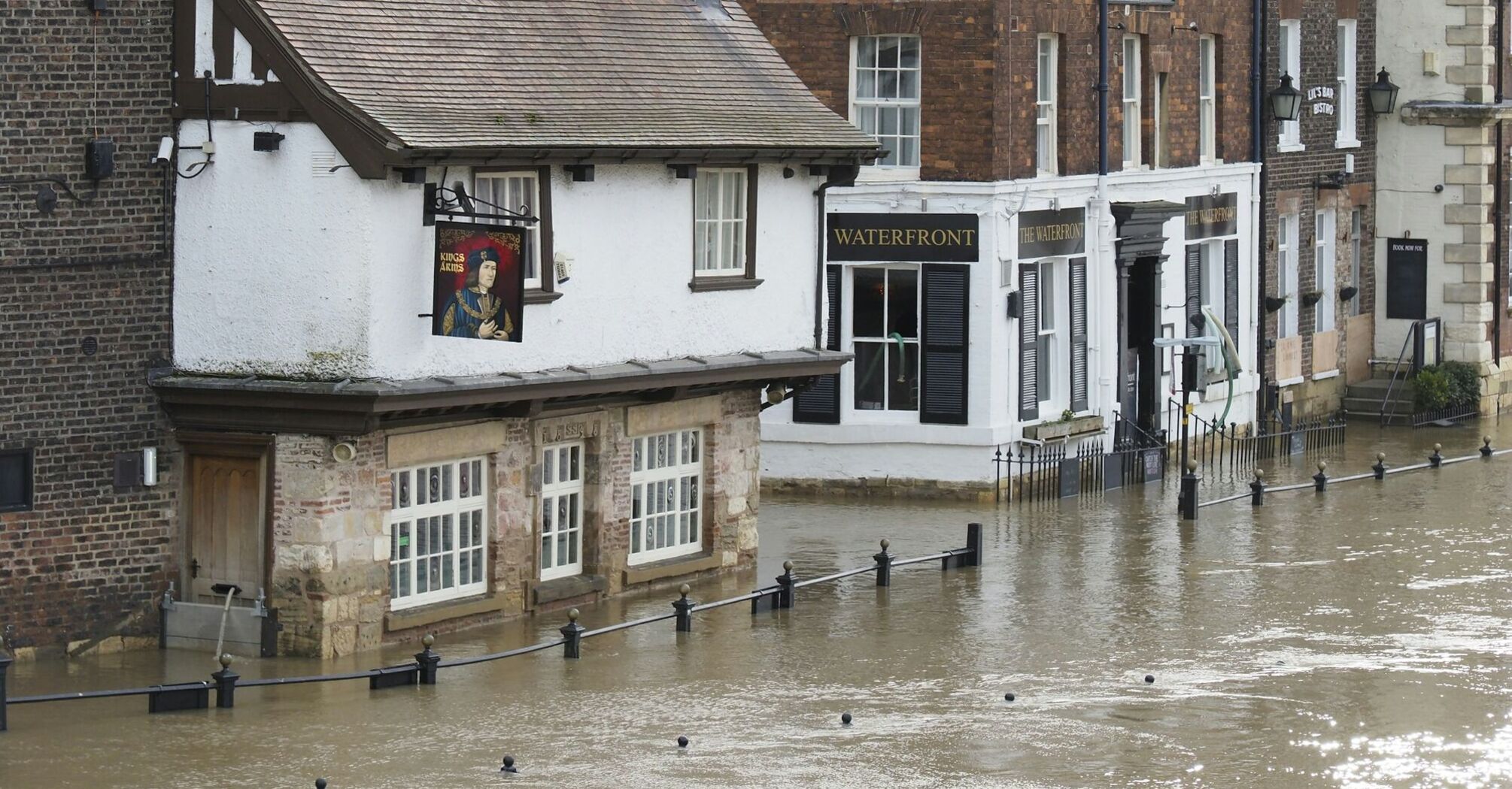 Flooded street near Rotherham Central station during heavy rainfall