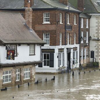Flooded street near Rotherham Central station during heavy rainfall