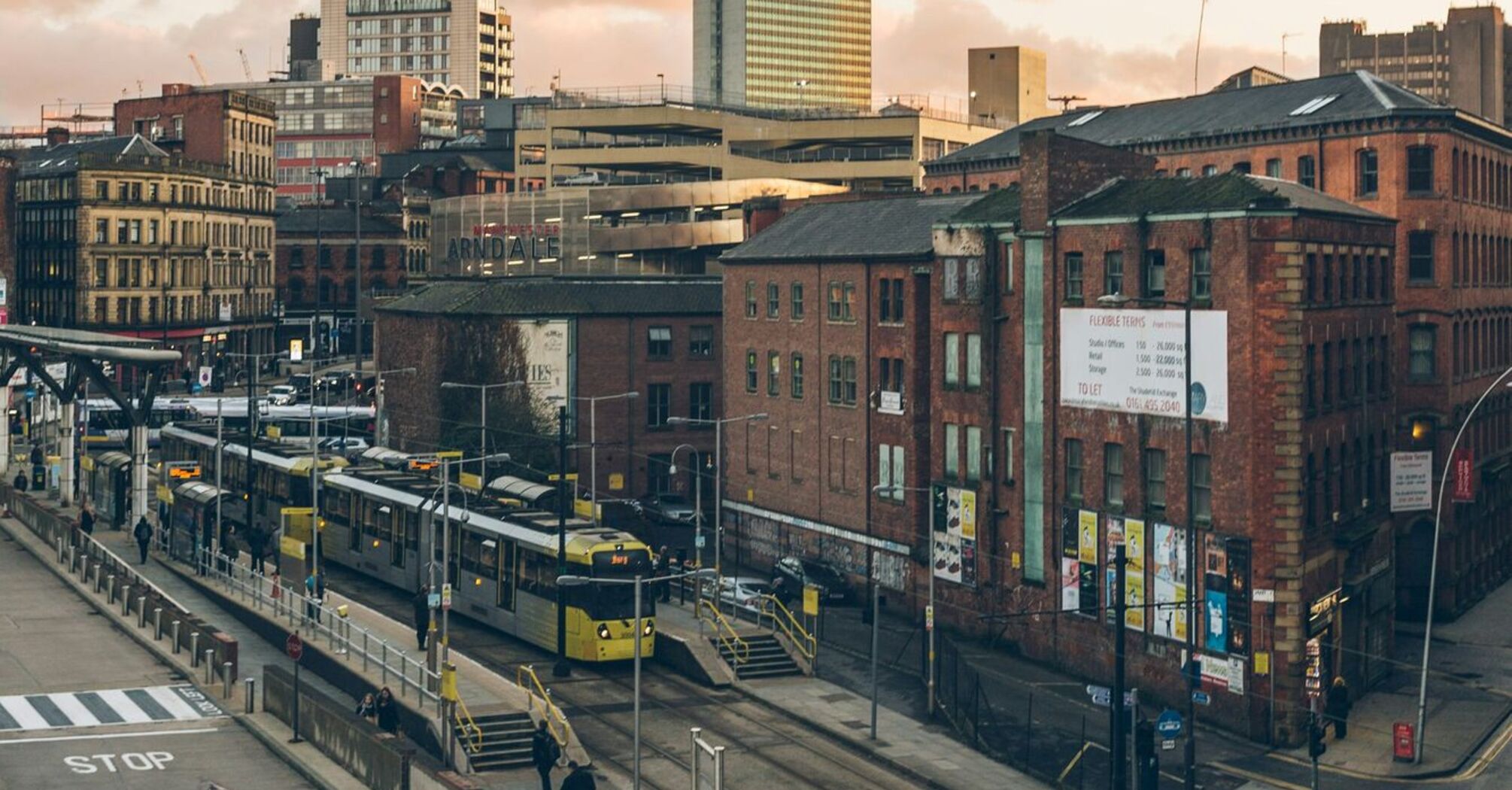 City view of Greater Manchester with trams and buses during the evening