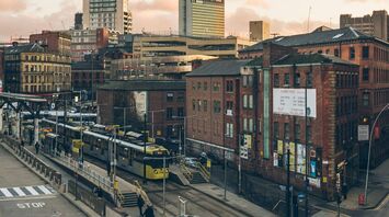 City view of Greater Manchester with trams and buses during the evening