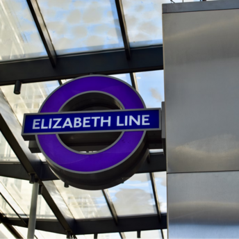 Purple Elizabeth Line logo under a glass canopy
