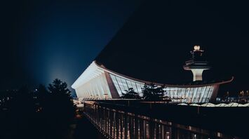 A night view of Washington Dulles International Airport showcasing its modern architectural design and iconic control tower