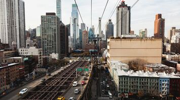 View of Roosevelt Island Tramway overlooking Manhattan's streets and buildings
