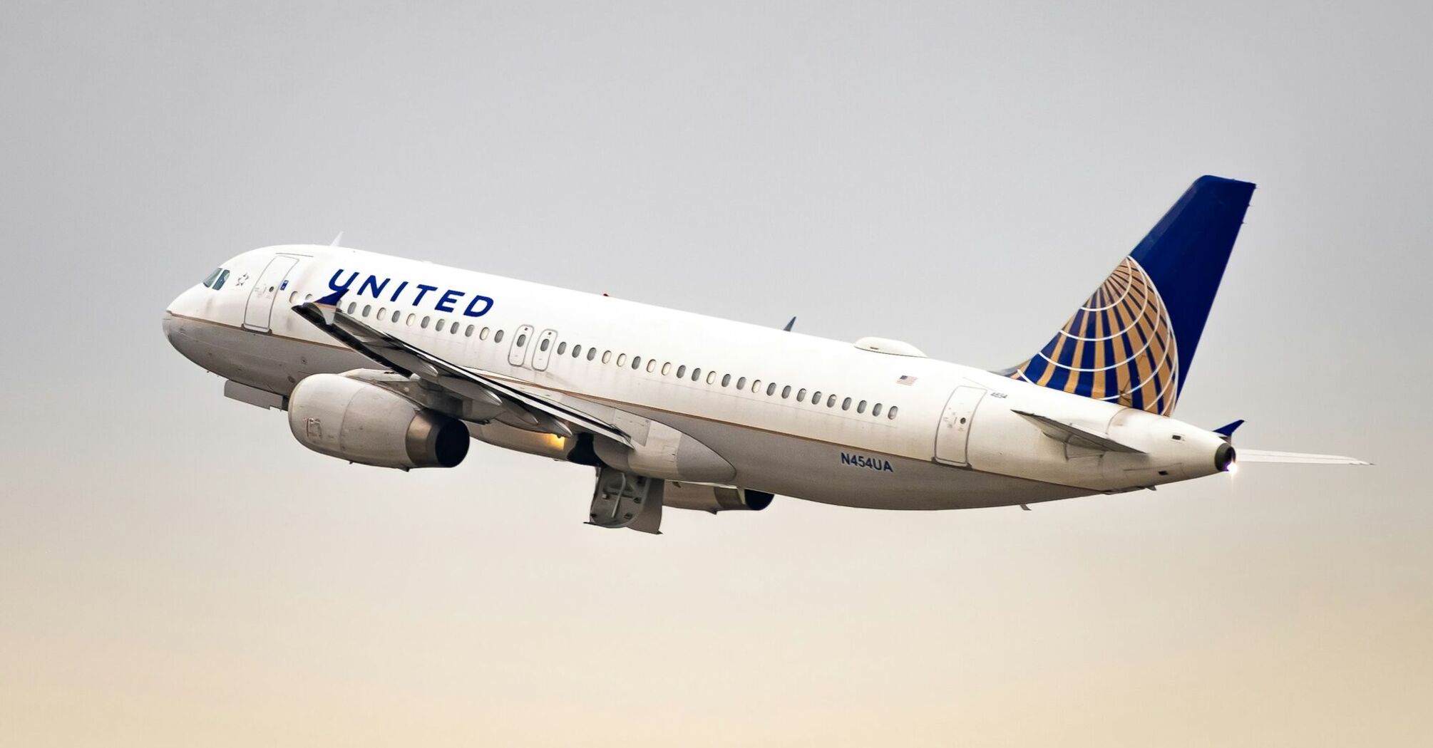 A United Airlines plane taking off into a clear sky, symbolizing travel and seasonal connectivity