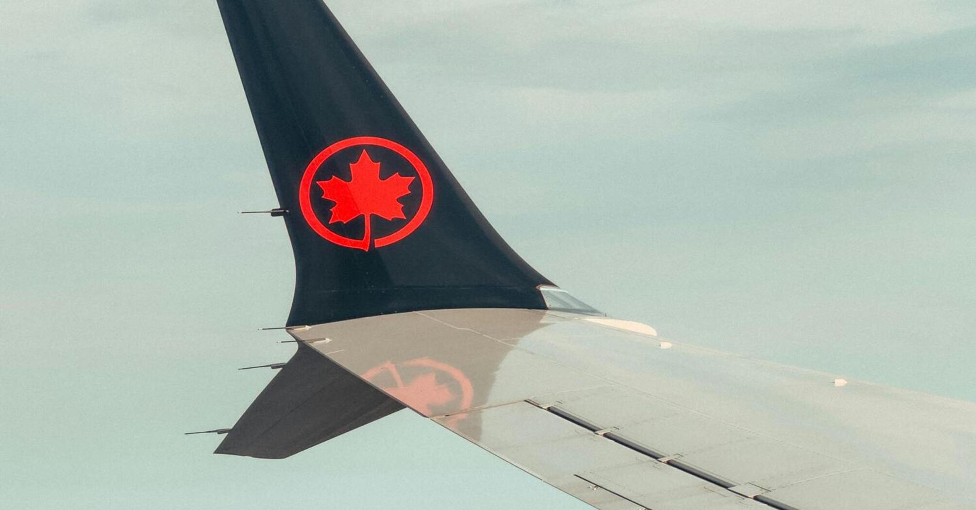 Air Canada airplane wing over Toronto skyline