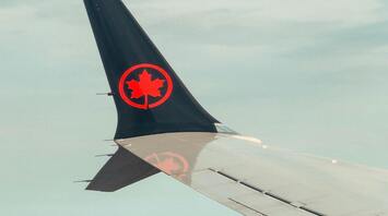 Air Canada airplane wing over Toronto skyline