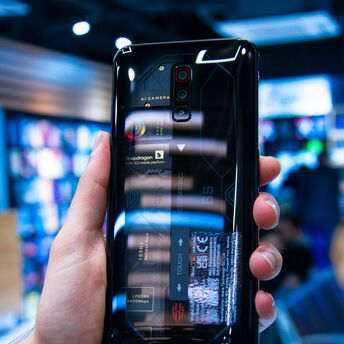 A smartphone showcasing transparent back design and internal components