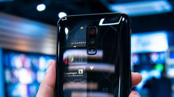 A smartphone showcasing transparent back design and internal components