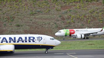 A TAP Air Portugal aircraft and a Ryanair plane on a runway surrounded by greenery