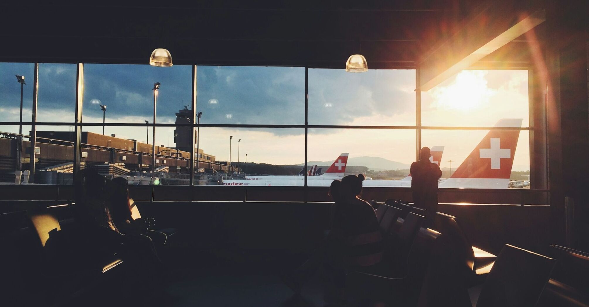 Airport view with SWISS planes at sunset