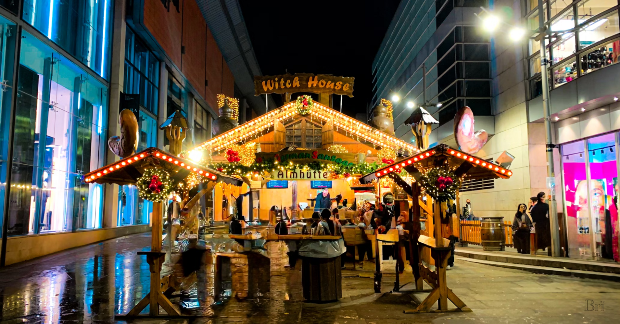 Festive Christmas market stall illuminated at night in Manchester city center