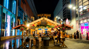 Festive Christmas market stall illuminated at night in Manchester city center