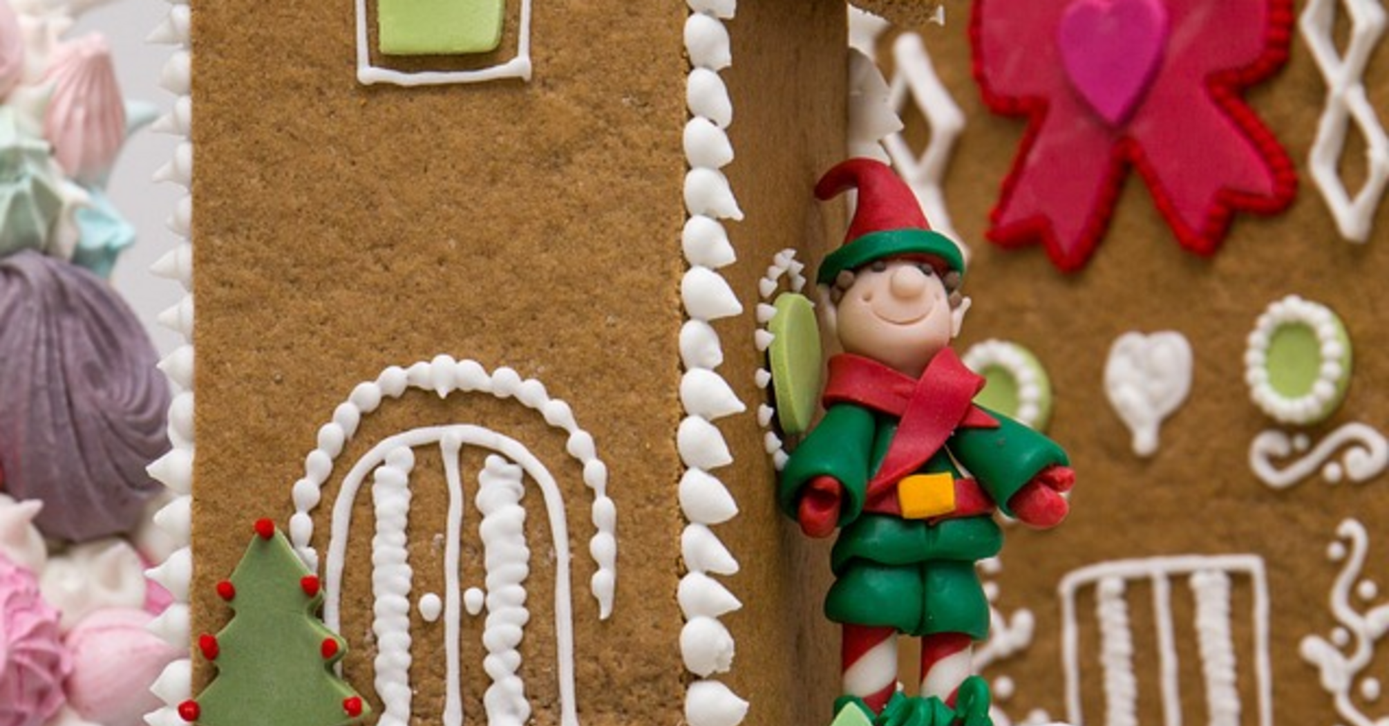 Decorated gingerbread cookie with an elf figurine