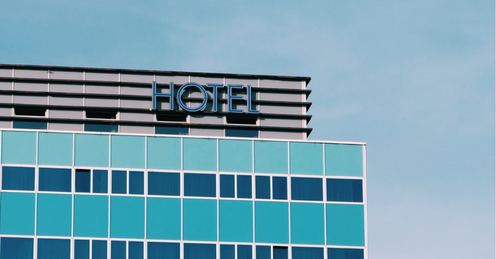 Modern hotel building with blue windows under a clear sky