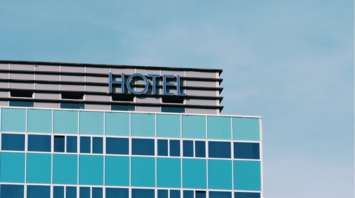 Modern hotel building with blue windows under a clear sky
