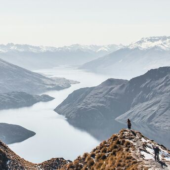 Panoramic view of snow-capped mountains and a lake in New Zealand