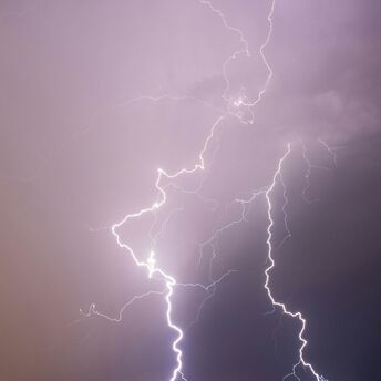 Multiple lightning bolts striking down from a stormy sky California, United States
